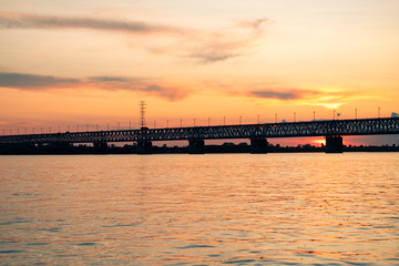 Fototapeta premium Bridge over the Amur river at sunset. Russia. Khabarovsk. Photo from the middle of the river.