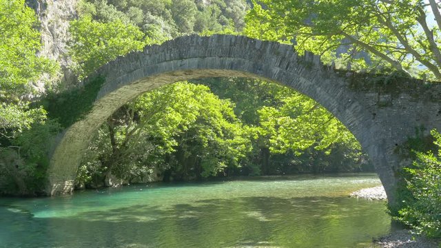 Medieval stone bridge. Konitsa bridge and Aoos River, Greece.