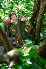 Elf archer with a bow in the forest