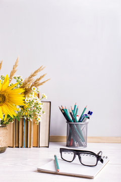 Teacher's day holiday greeting icon. Education knowledge concept. Wooden chalk board frame and vase bouquet on table empty copy space.
