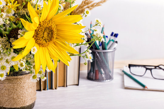 Teacher's day holiday greeting icon. Education knowledge concept. Wooden chalk board frame and vase bouquet on table empty copy space.