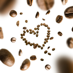 Coffee beans in the shape of a heart in flight on a white background