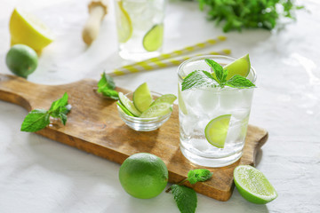 Glass of fresh mojito on table