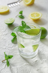 Glass of fresh mojito on light table