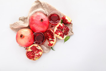 Obraz na płótnie Canvas Composition with fresh pomegranates and juice on light background