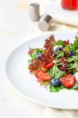 Plate with fresh tasty salad on table, closeup