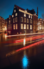 Canal and buildings in Amsterdam at night