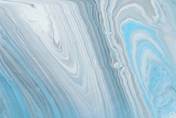 photography of abstract marbleized effect background. Blue, gray and white creative colors....