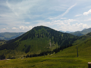 Fototapeta na wymiar Beautiful alpine landscape with green meadows, alpine cottages and mountain peaks, Tyrol Alps, Austria