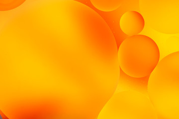 bright oily drops in water with colorful background, close-up 