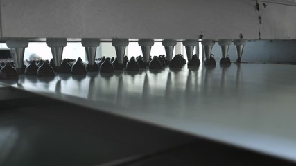 Chocolate candy bars production - food industry process. A lot of chocolates on the production line.