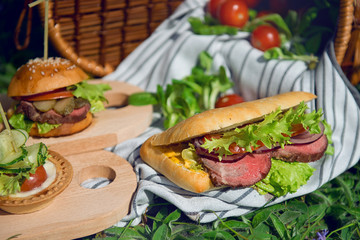 Ham sandwich on a sunny day during a picnic.