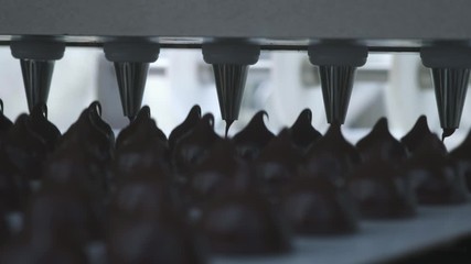 Chocolate candy bars production - food industry process. A lot of chocolates on the production line.
