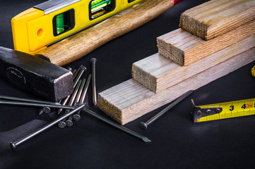 Professional tools for carpentry and accessories on a black background.