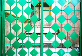 Green metal doors. Rhombic pattern. Old vintage style.