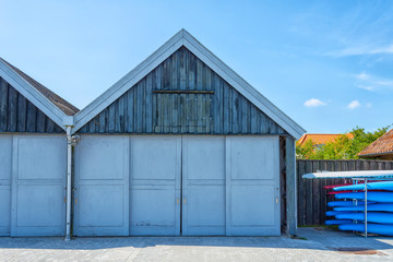 Fototapeta na wymiar Beautiful wooden garage door for boats. Architecture. Details