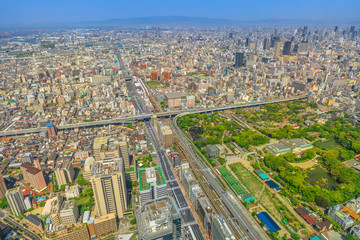 Aerial view of Osaka skyline from observation deck of viewing platform of a top of Osaka's Abeno Harukas, the tallest skyscraper in Japan. Sunny day.