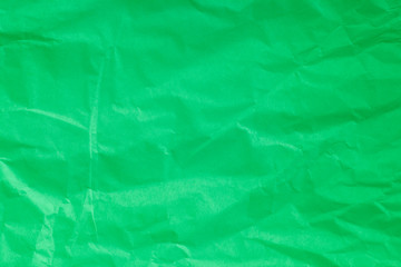 Green crumpled paper background.