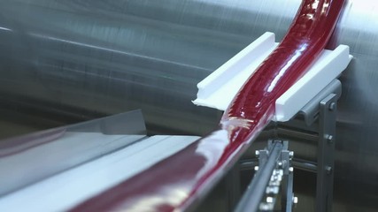 Manufacture of caramel candies. making lollypop. Production of caramel sweets. Lollipops on the production line. Long caramel mass.