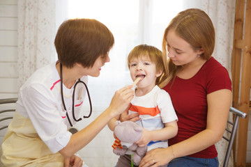 Beautiful mother and her little son at the reception at the doctor