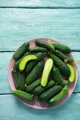 cucumbers in a bowl on wooden surface