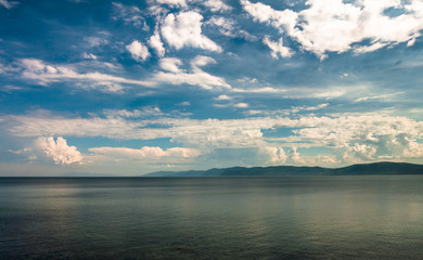 Lake Baikal. View of the sky above the lake and mountain range on the horizon.