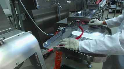 Manufacture of caramel candies. making lollypop. Production of caramel sweets. Lollipops on the production line. Long caramel mass.