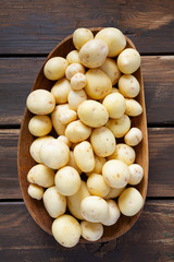 new potatoes on a brown wooden surface