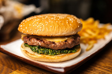 Delicious burger with fries on white plate