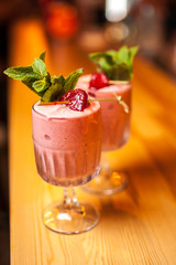 Close-up strawberry smoothie cocktails with strawberries and mint on the bar