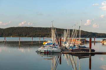 Boat station with yachts on Lake Brombach in the evening at sunset