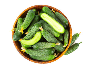 cucumbers in a bowl isolated on white