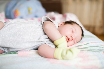 newborn sleeping in mittens. Protect your hands from accidental scratches in your sleep. mother care