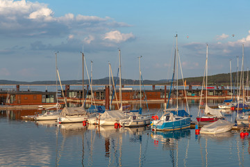 Fototapeta na wymiar Boat station with yachts on Lake Brombach in the evening at sunset