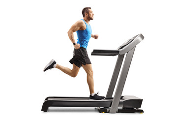 Muscular man running on a treadmill