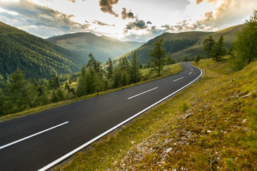 Asphalt road in Austria, Alps in a summer day. © Lukas Gojda