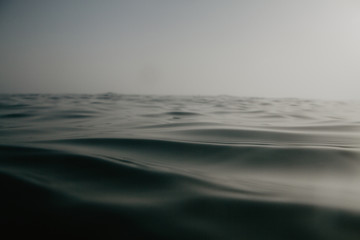 Close up of the waterline inside the mediterranean sea. Relax sunset in the water. Neutral colors