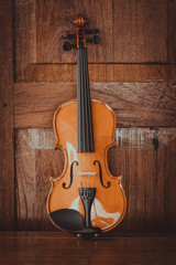 Close up of a violin shallow deep of field on wood background