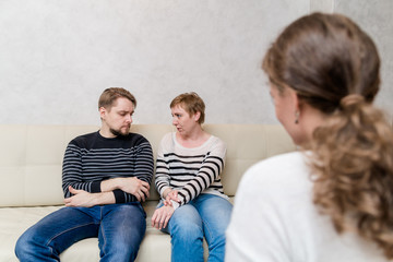 unhappy couple at the reception at the psychologist talks about the problems in family life