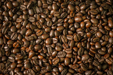 Fototapeta premium Roasted Coffee beans dark brown color background.
