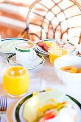 Healthy breakfast with fresh juice and sweet croissant in restaraunt resort outdoor