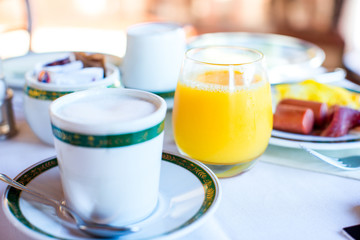 Healthy breakfast with fresh juice and sweet croissant in restaraunt resort outdoor