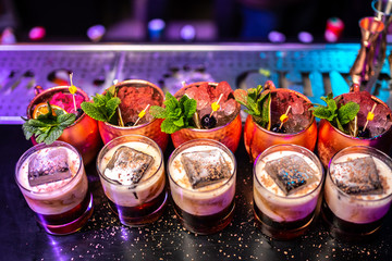 Cocktails with mint, cherry and dried lime on the bar