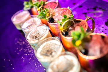 Cocktails with mint, cherry and dried lime on the bar