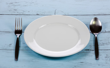 Spoon and fork on white plate