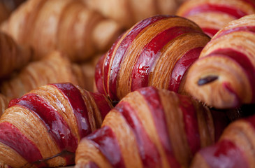 tasty fresh striped croissants in a shop window or in a pastry shop