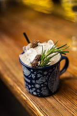 Closeup cocktail with cone jam and rosemary in blue cup