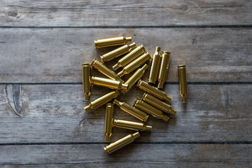 Brass bullet casing on wood background