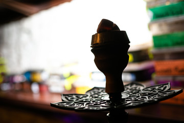 Shisha hookah bowl with red hot coals. Modern hookah with coconut charcoal and shisha smoke.