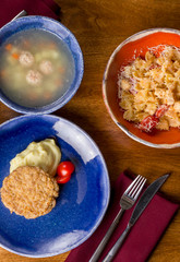Table with food, top view. Having healthy lunch. Soup, pasta and chiken with potato. Different meat set for a dinner. Vertical. Healthy eating, tasty, food. Diet, holidays, recipe concept